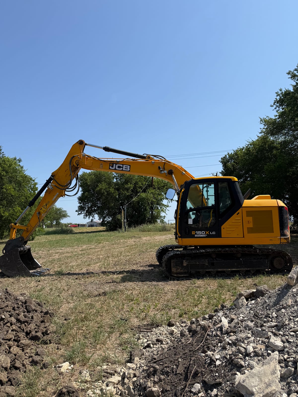 Kickin K Services JCB 150X LC excavator on a North Texas job site