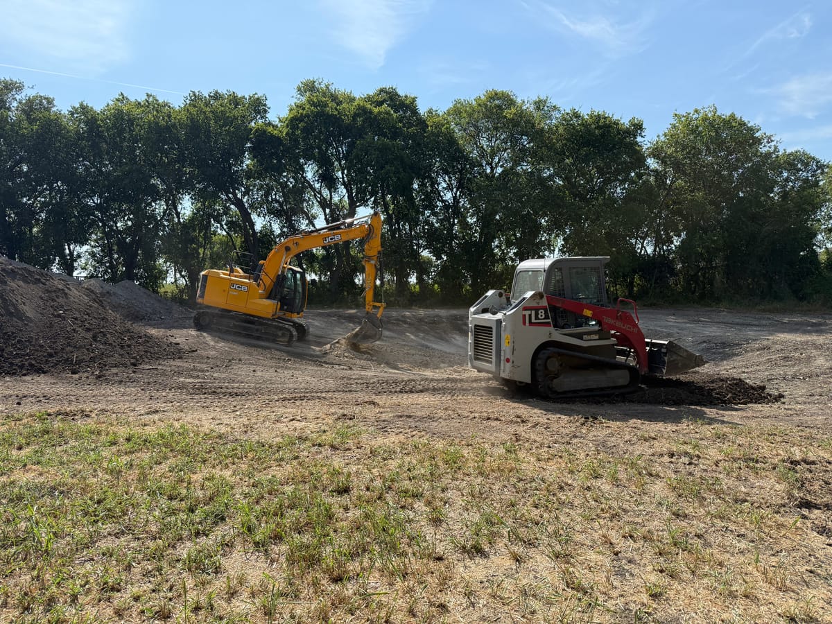Kickin K Services JCB excavator and Takeuchi track loader grading a jobsite in the Blue Ridge, TX area